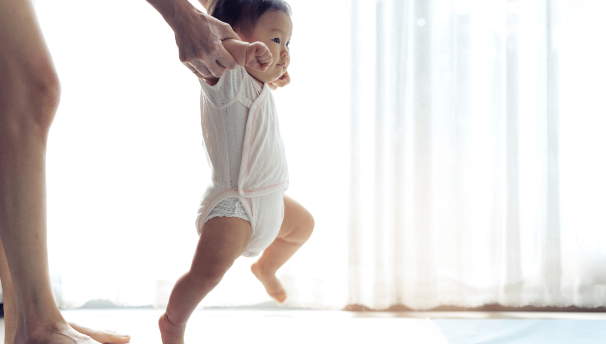 asian baby taking first steps walk forward on the 2021 12 09 17 46 26 utc