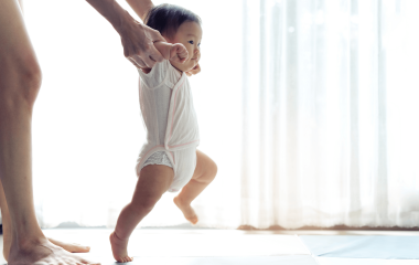 asian baby taking first steps walk forward on the 2021 12 09 17 46 26 utc